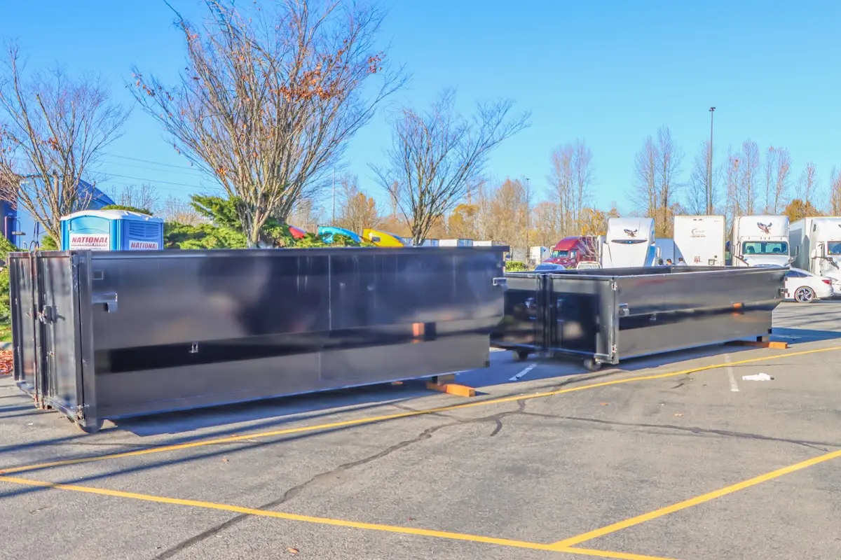 Professional dumpster rental service with roll-off container on residential driveway in Snyderville